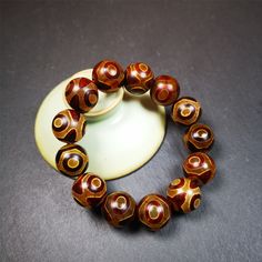 ❤ This 3 eyes bracelet was hand-woven by Tibetans,It's made of 3 eyes round dzi beads,brown color,diameter is 0.63", the circumference of bracelet is 7.5".It can be worn not only as a fashionable accessory but also holds cultural and religious significance.❤ Details:Bracelet length is about 19cm / 7.5 inches.Include 13 beads of 3 Eyed Dzi( diameter 16mm / 0.63").Products are shipped within a deluxe jewelry box.Utilize the deluxe jewelry box to present pieces as gifts to friends, significant othe Hippie Brown Round Bead Bracelets, Earthy Hand-strung Wrap Bracelet With Round Beads, Dzi Bracelet, Dzi Beads Meaning, Hand-strung Agate Beaded Bracelets With Round Beads, 3rd Eye, Agate Beads, Turquoise Beads, Brown Color