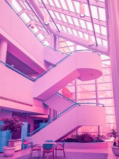 the inside of a building with stairs and tables