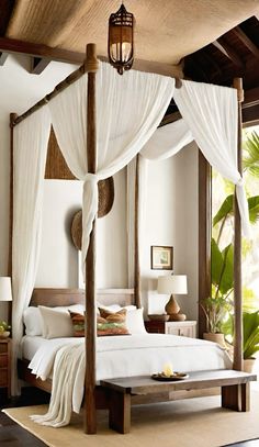 a canopy bed with white drapes and pillows on top of it in a bedroom