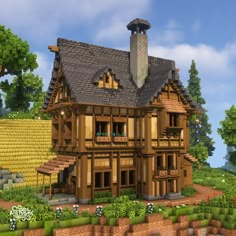 a large wooden house sitting on top of a lush green field