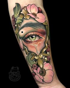 a woman's face with flowers and leaves on her arm, in the shape of an eye