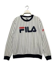 "ACTUAL MEASUREMENTS    ➡️Label: Fila    ➡️Size on Tag: L    ➡️Armpit to Armpit: 21 \"inch    ➡️Collar to hem (Lenght): 25 \" inch    ➡️Colour: White    ➡️Material: view picture's    ➡️PLEASE CHECK THE MEASUREMENTS CAREFULLY AND MAKE SURE THE ITEMS MATCH YOUR BODY ⬅️    ➡️Condition: Used & Vintage item.    ➡️All details: View picture's    📌ATTENTION     All previously used items except those specified. Please understand the state of the item    📌PAYMENT    Receives only 'PAYPAL'    📌OTHERS Sporty Striped Winter Tops, Sporty Striped Tops For Winter, Winter Sporty Striped Tops, Sporty Striped Crew Neck Sweatshirt, Striped Crew Neck Sweatshirt For Streetwear, Sports Tops With Ribbed Crew Neck, Crew Neck Sports Top With Ribbed Collar, Sports Top With Ribbed Crew Neck, Striped Crew Neck Sweatshirt With Ribbed Collar