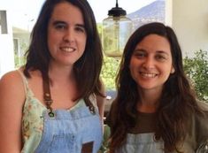 two women standing next to each other smiling