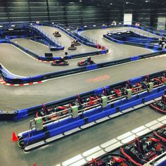 an indoor race track with cars on it