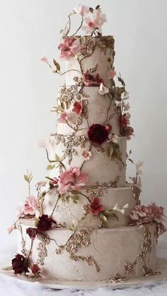 a three tiered wedding cake with flowers on it