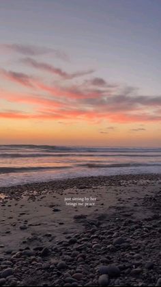 a beach with rocks and the ocean in the background at sunset, with an inspirational quote written on it