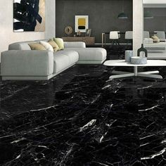 a living room with black marble flooring and white couches in the middle of it