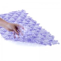 a person is cleaning the floor with a purple rag on top of it, while another hand reaches for something