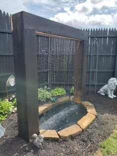 an outdoor water fountain in the middle of a garden