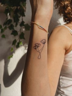 a woman's arm with a tattoo on it and a flower in the middle