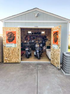 two motorcycles are parked in a garage with the doors open to show them's inside