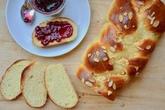 bread with peanut butter and jelly spread on it next to slices of toasted bread