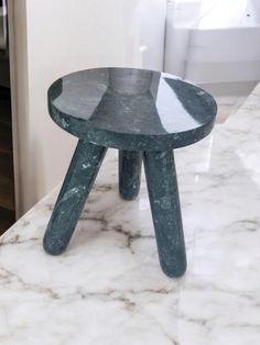 a marble counter top with a stool on it