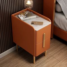 an orange bedside table with a phone on it