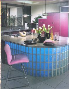 a kitchen with a blue counter top and purple chairs