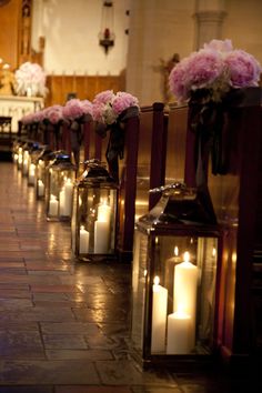 many lit candles are lined up on the floor