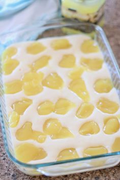 a casserole dish filled with lemon custard and white icing in a glass baking dish