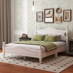 a white bed sitting in a bedroom on top of a hard wood floor next to a window