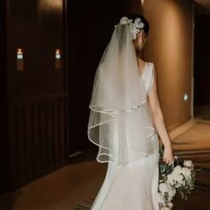 a woman in a wedding dress holding a bouquet