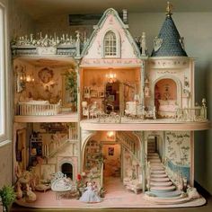 a doll house with lots of furniture and decorations on the top floor is shown in front of a window