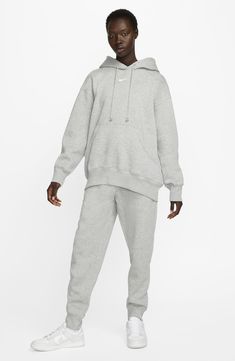 Exaggerated features like an oversized kangaroo pocket and extra tall ribbing add to the roomy feel of this sporty hoodie with a cozy brushed fleece interior. Drawstring hood 80% cotton, 20% polyester Machine wash, dry flat Imported Cozy Nike Cotton Sweats, Cozy Cotton Nike Sweats, Relaxed Fit Hooded Cozy Sweats, Cozy Hooded Sweats With Relaxed Fit, Cozy Relaxed Fit Hooded Sweats, Adjustable Hood French Terry Sweats For Loungewear, French Terry Sweats With Adjustable Hood For Loungewear, Hooded Sportswear Sweatshirt With Pockets, Nike Relaxed Fit Fleece Sweats