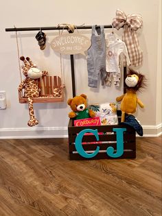 stuffed animals and clothes are on display in front of a sign that says welcome to the child