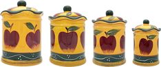 three ceramic canisters with apples painted on the front and sides, one is yellow