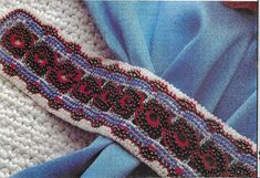 a close up view of a blue and white knitted scarf with the word love written on it