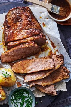 meat, potatoes and sauces are on a plate next to a cup of coffee