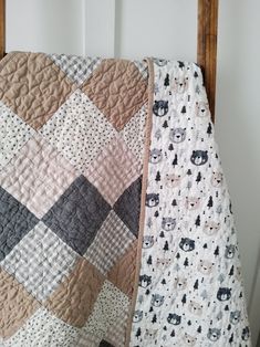 two quilts are laying next to each other on a bed with a wooden headboard