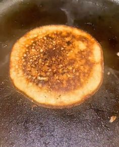 some food is cooking in a pan on the stove top and it appears to be fried