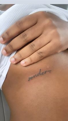 a woman's stomach with the word soldier written on it, in cursive font