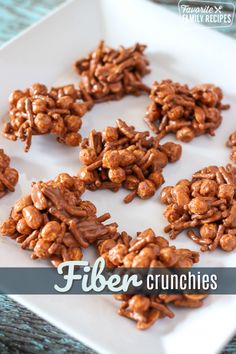 chocolate granola clusters on a white plate with the words fiber crunchies over it