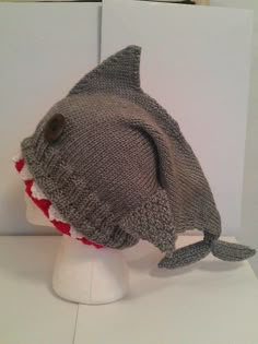 a knitted hat with a shark head on top of a mannequin's head