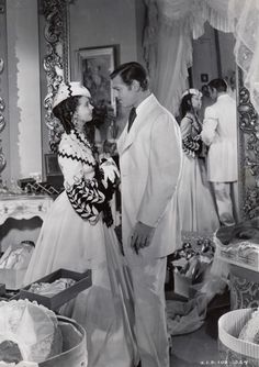 an old black and white photo of a man and woman dressed up in wedding attire