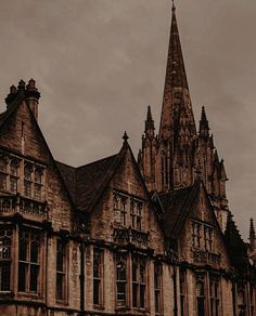 an old building with a steeple and clock on the top is shown in sepia