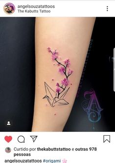 a small tattoo with pink flowers on the left arm and an origami bird