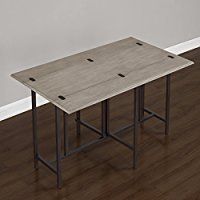 a table that is on top of a hard wood floor in front of a white wall