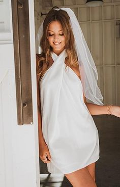 a woman wearing a white dress and veil