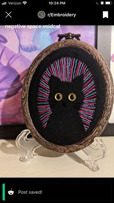 a close up of a small embroidered object with a cat on it's face