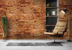 a living room with brick walls and a chair in front of the wall is a potted plant