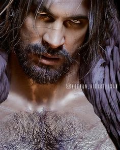 a man with long hair and wings on his chest is shown in this artistic photo