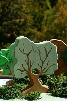 three wooden trees sitting on top of a table