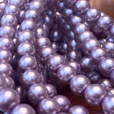 a bunch of pearls sitting on top of a wooden table