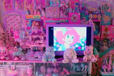 a tv sitting on top of a pink shelf filled with toys