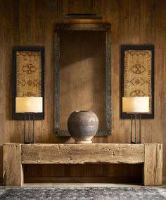 a wooden table with two lamps and a vase on it in front of a mirror