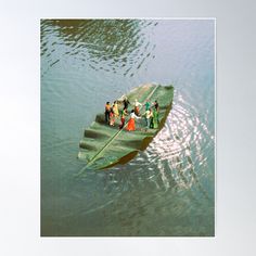 a group of people on a boat floating in the water with their backs to each other