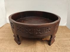 a wooden bowl sitting on top of a table