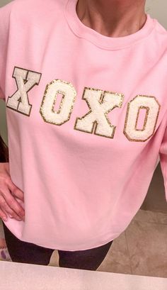 XOXO in chenille patches with the option of white and turquoise colors.  Each letter is surrounded by gold glitter.  Customize your item with your choice of shirt color and patches. Please keep in mind that a shirt can only fit a certain amount of letter patches.  It can only be two lines and the smaller the shirt, the less amount of space. Primary Color option is the shirt.   No returns or exchanges on customized items. Please contact me at any time for concerns about your purchase. Care instructions: Turn inside out and wash on gentle or handwash.  Hang to dry. Chenille Letter Patch Ideas, Christmas Chenille Patch Sweatshirt, Chenille Shirt Ideas, Chenille Letter Ideas, Valentines Shirt Ideas, Valentine Shirts For Women, Vsco Clothes