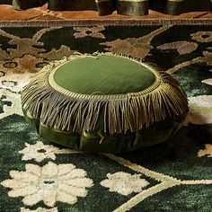 a green cushion sitting on top of a rug